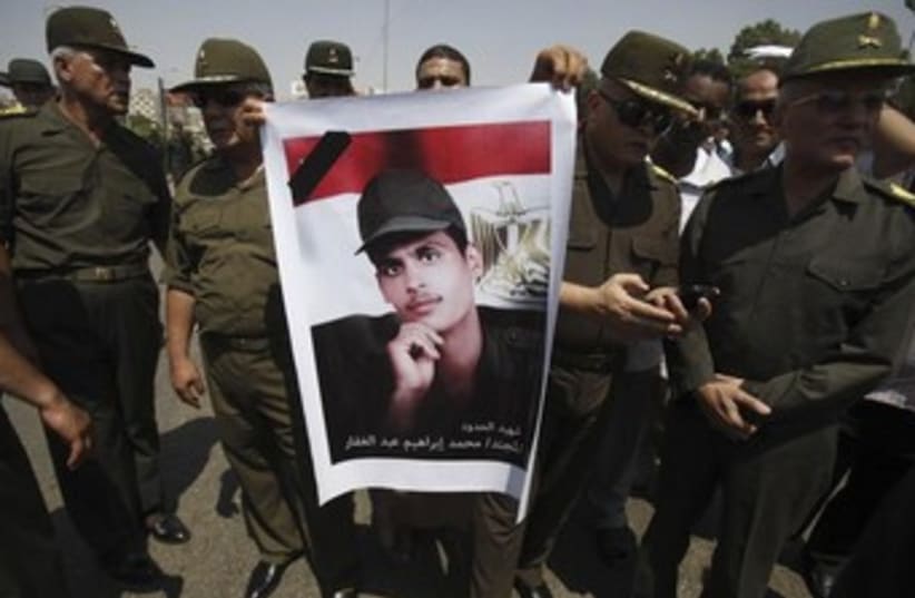 egyptian soldiers hold poster of dead brother 370 (photo credit: REUTERS)