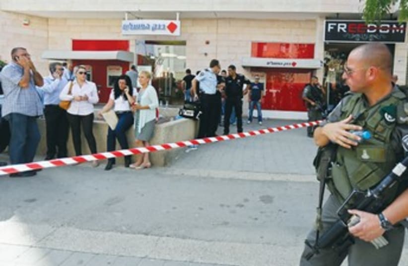 Policeman at Beersheba shooting scene 370 (photo credit: REUTERS)