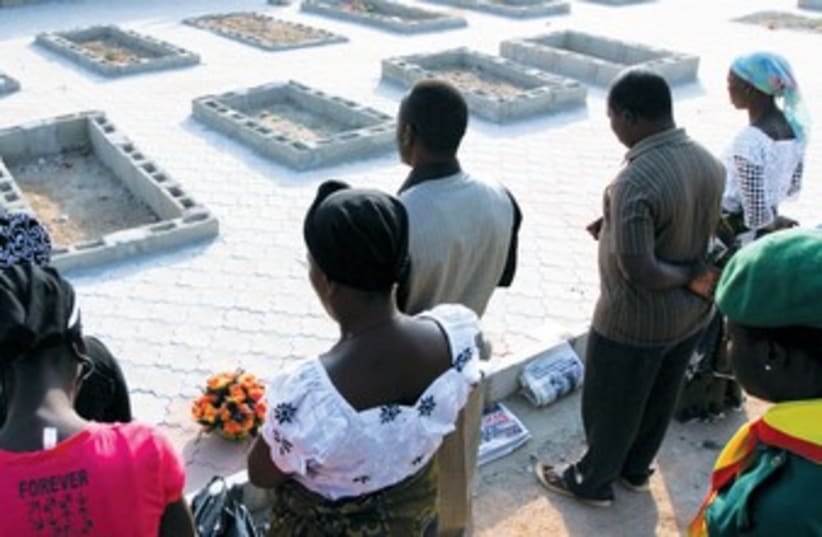 Nigerian mourners at graves 370 (photo credit: REUTERS)