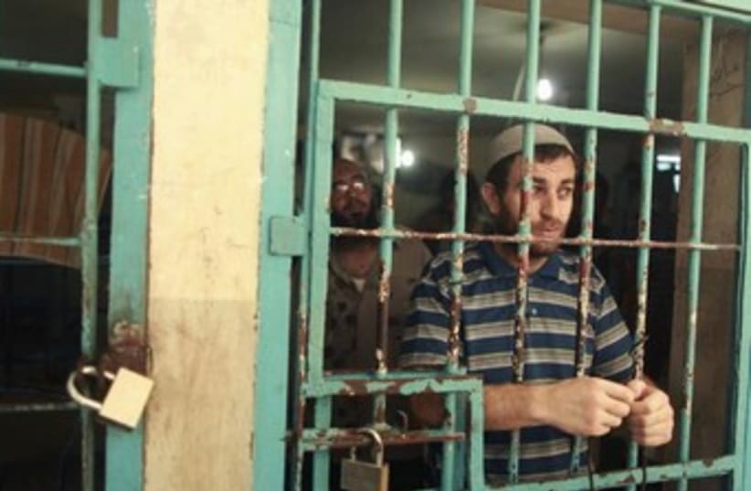Gazan behind prison bars 370 (photo credit: REUTERS/Mohammed Salem )