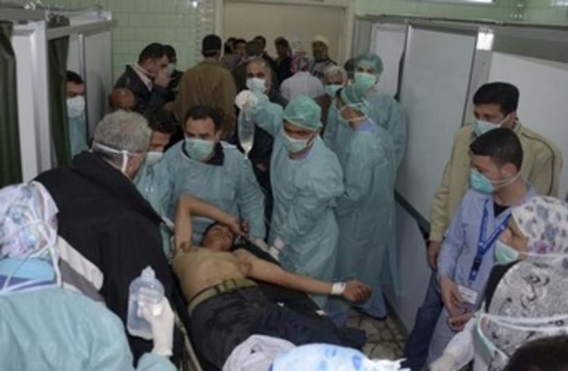 injured man in apparent chemical attack 370 (photo credit: REUTERS/George Ourfalian)