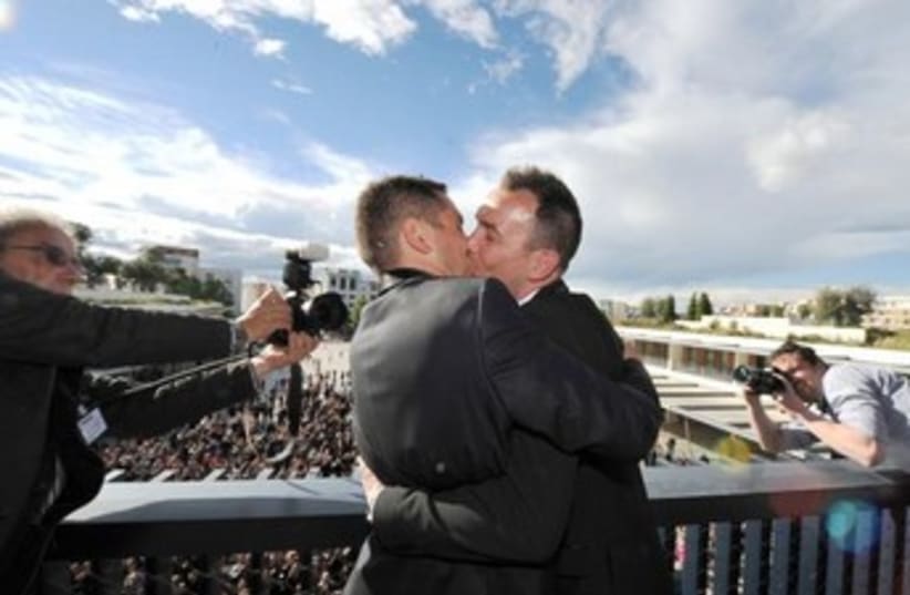 Vincent Autin (R) and Bruno Boileau kiss (photo credit: REUTERS/Jerard Julien/Pool)