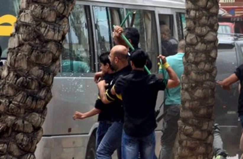 hezbollah protesters attack bus 370 (photo credit: reuters)
