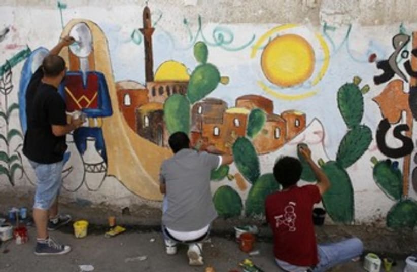 Palestinian refugees paint mural of Jlem in refugee cam, 370 (photo credit: REUTERS/Ammar Awad)
