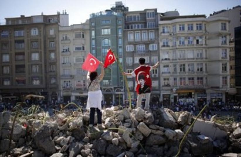 Protesters wave Turkish flags  (photo credit: Reuters)