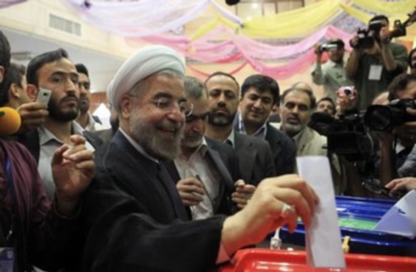 Hassan Rohani votes 370 (photo credit: REUTERS/Yalda Moayer)