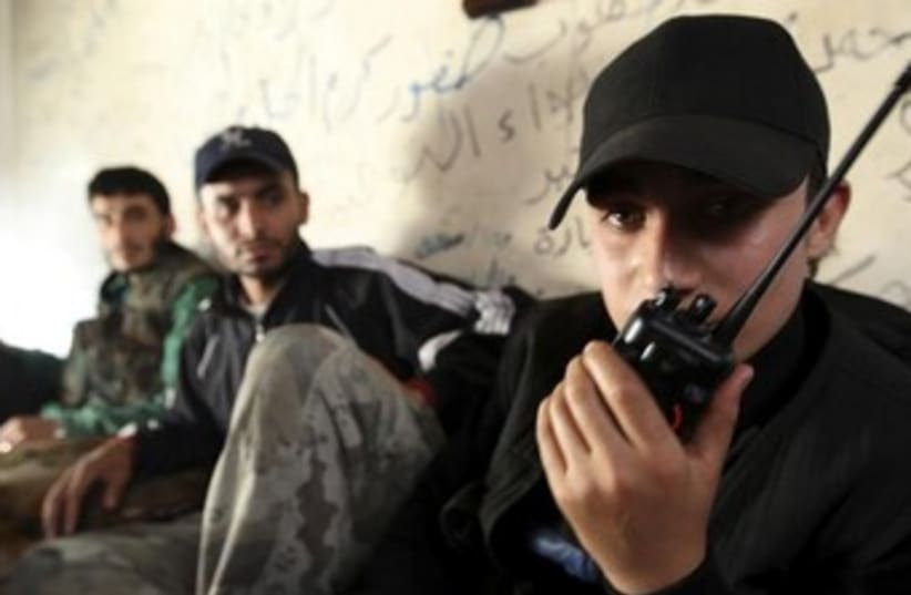 Syrian Rebels on the radio 370 (photo credit: REUTERS)