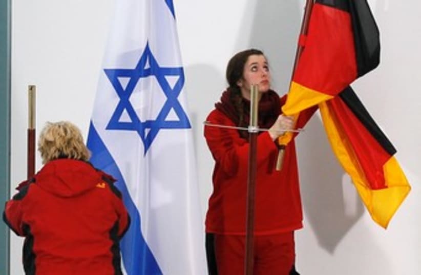 A WOMAN removes a German flag 370 (photo credit: reuters)