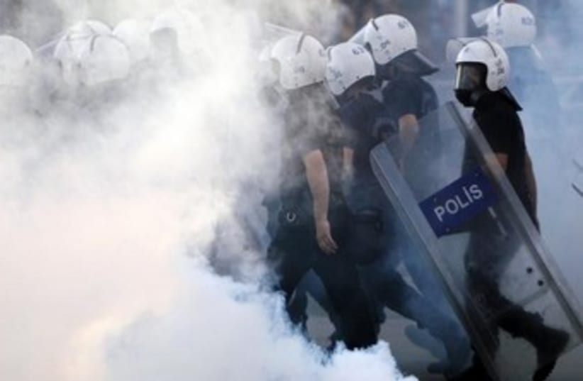 Turkey police walk through tear gas 370 (photo credit: REUTERS)