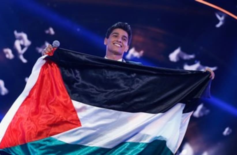 Mohammed Assaf with flag after Arab Idol win370  (photo credit: REUTERS)