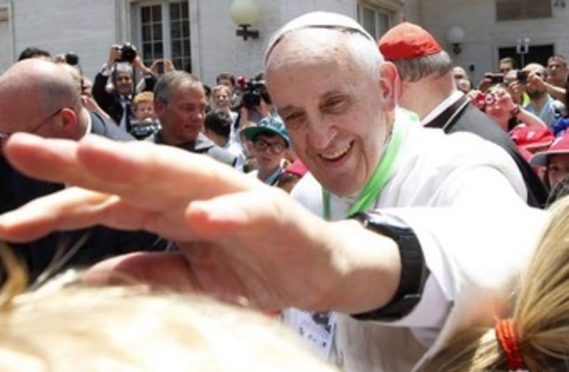 Pope francis extending hand, smiling 370 (photo credit: REUTERS)