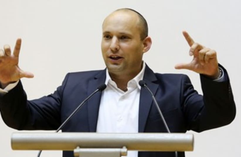 Bennett taking pictures on giant imaginary camera 370 (photo credit: Marc Israel Sellem/The Jerusalem Post)
