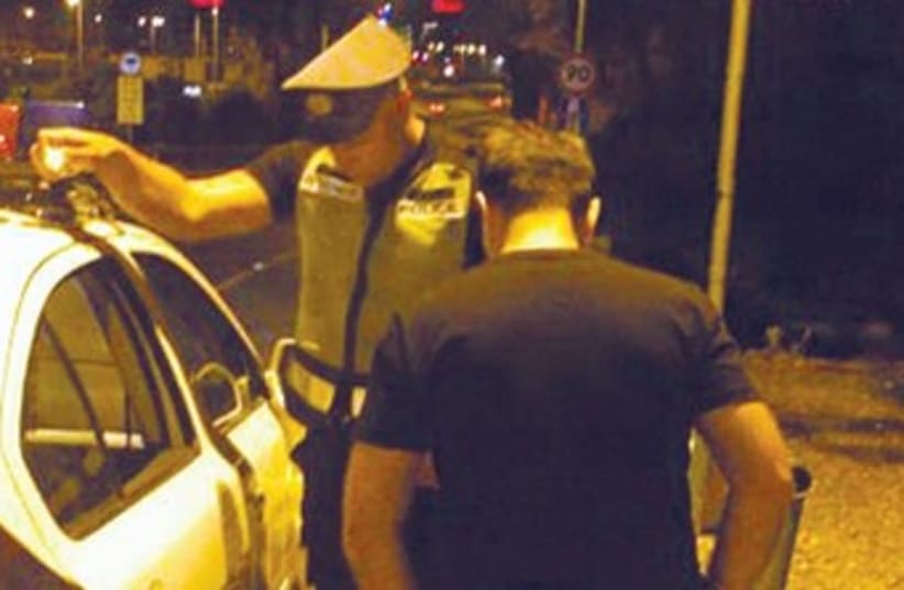 A traffic officer checks a driver in Tel Aviv 370 (photo credit: Ben Hartman)