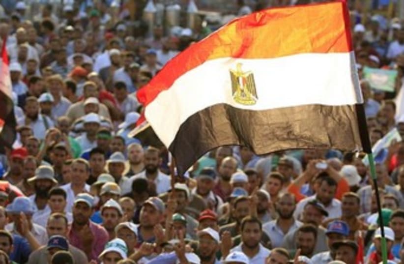 protesters wave egyptian flag 370 (photo credit: REUTERS)