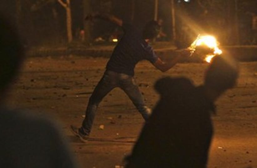 Egypt protester throws molotov cocktail 370 (photo credit: REUTERS)