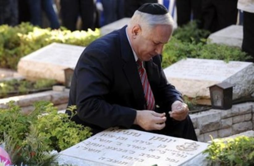 Netanyahu by brother's grave 370 (photo credit: REUTERS/Ahikam Seri/Pool)