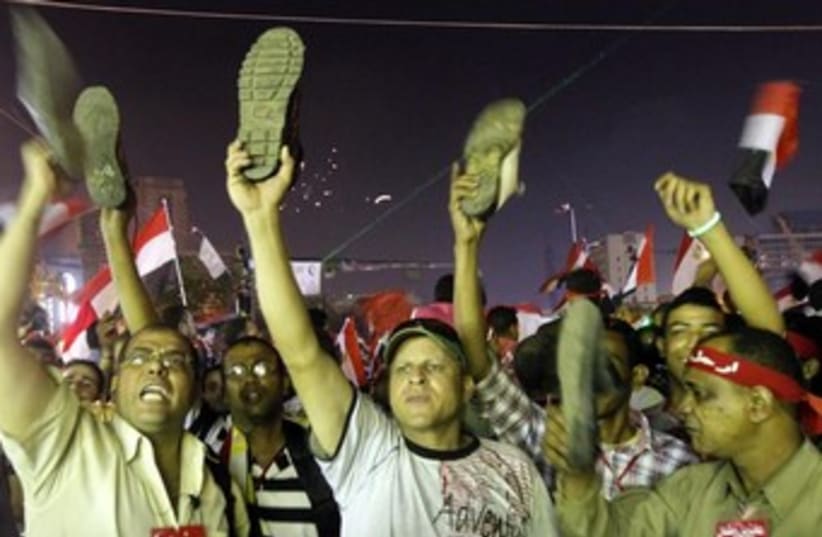 egypt opposition protesters at night with shoes 370 (photo credit: REUTERS)