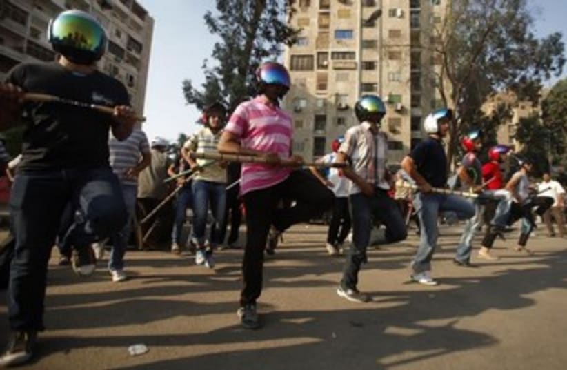 Mohamed Morsi supporters perform drill in Cairo 370 (photo credit: Reuters)