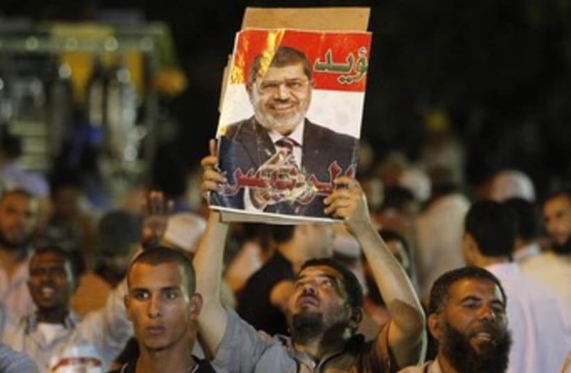 Muslim Brotherhood hold poster of Morsi July 4 2013 370 (photo credit: REUTERS/Louafi Larbi)
