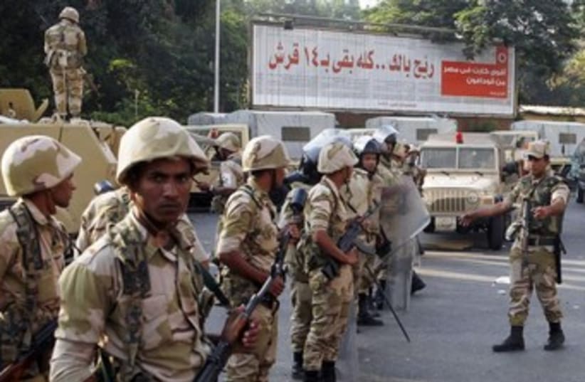 Egyptian army stands guard near Morsi supporters370 (photo credit: REUTERS)