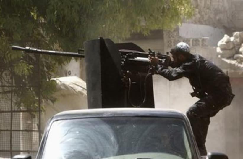 Syrian Islamist rebel shoots big gun 370 (photo credit: REUTERS)
