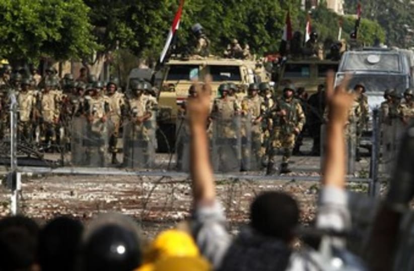 Egyptian army stands guard near Morsi supporters370 (photo credit: Reuters)