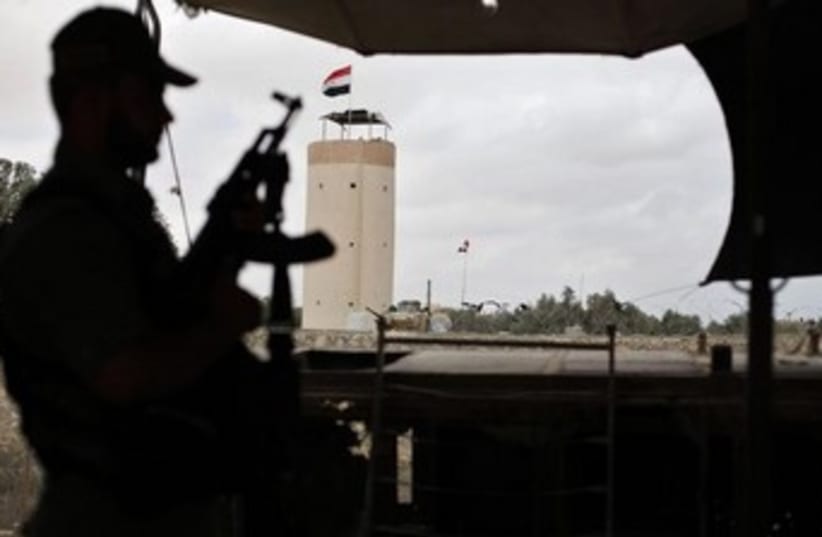 A Palestinian officer on alert near the border with Egypt370 (photo credit: Reuters)