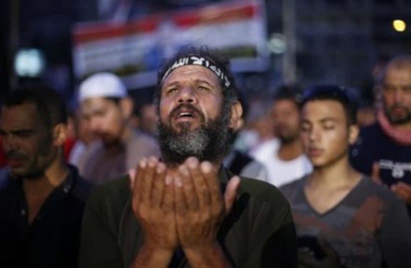 morsi supporter with hands out 370 (photo credit: REUTERS)