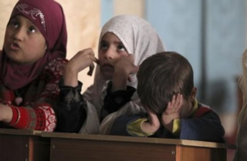 Syrian kids in lesson looking glum 370 (photo credit: REUTERS/ Giath Taha)