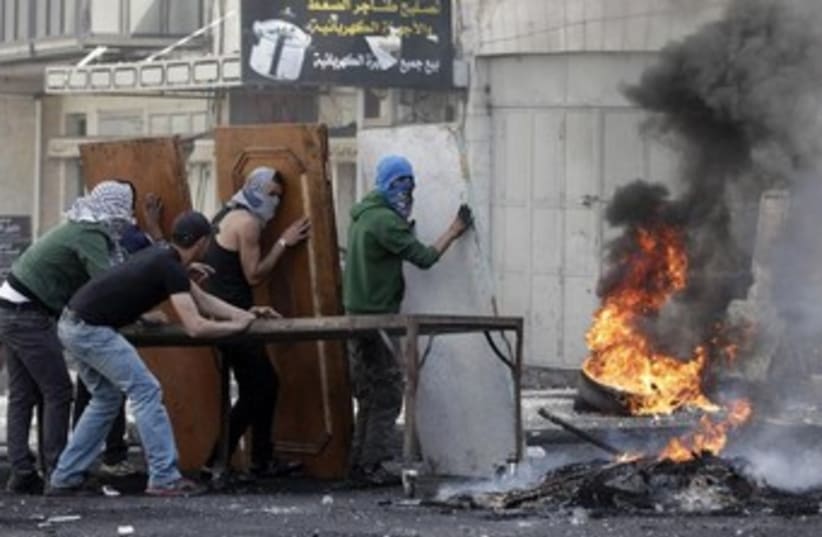 Palestinians clashing with IDF troops in the West Bank370 (photo credit: Reuters)
