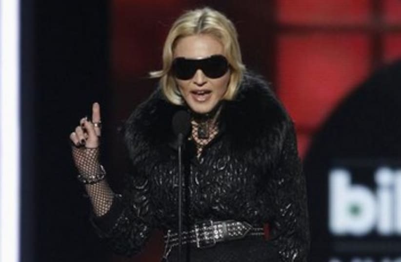 Singer Madonna accepts an award (photo credit: REUTERS/Steve Marcus)