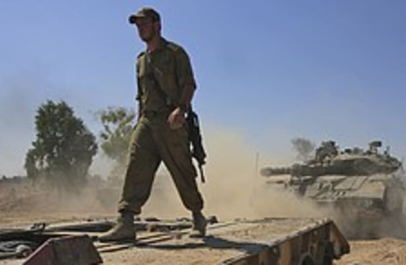 Soldier walks on tank  (photo credit: AP)