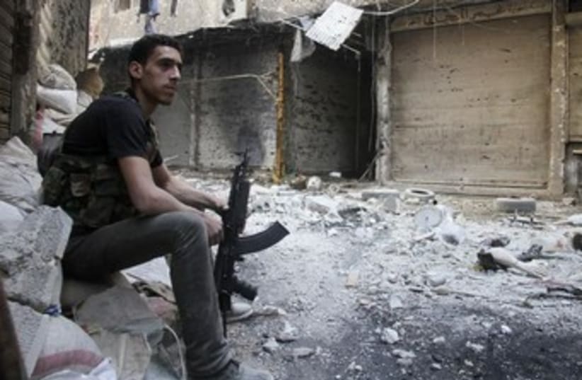A Free Syrian Army fighter in Yarmouk refugee camp 370 (photo credit: REUTERS)