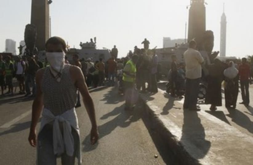 anti morsi protesters, kid with face covered 370 (photo credit: REUTERS)