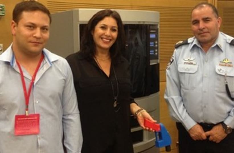 Miri Regev with a plastic gun 370 (photo credit: Knesset Spokesman's Office)