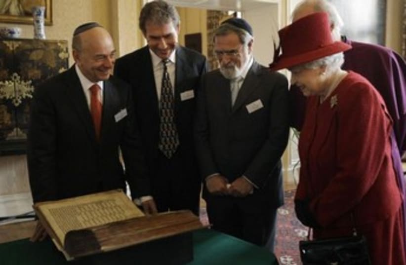 Britain's Queen Elizabeth is shown the Codex Valmadonna book (photo credit: REUTERS)