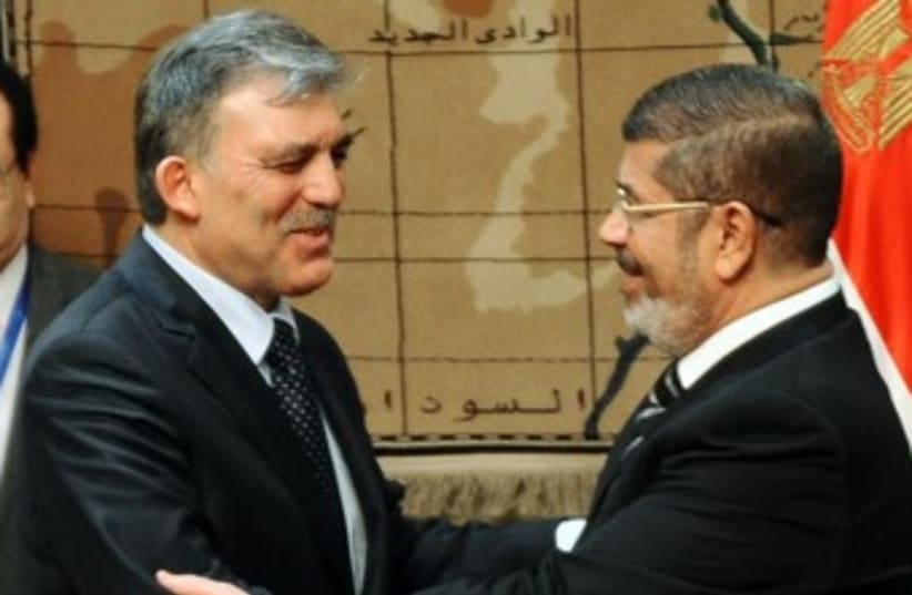 Turkish President Gul with deposed Egyptian President Morsi  (photo credit: REUTERS)