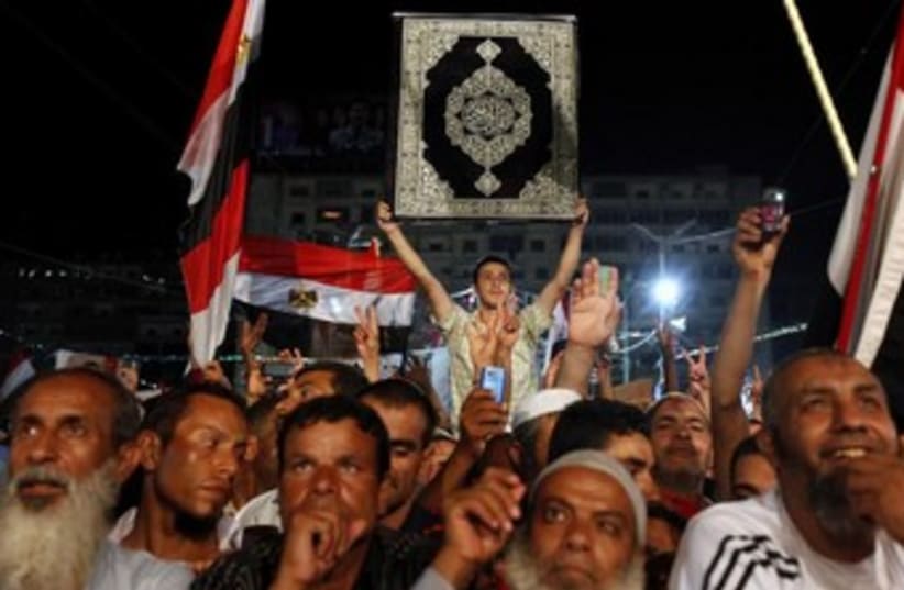 Morsi supporters night with Koran 370 (photo credit: REUTERS)
