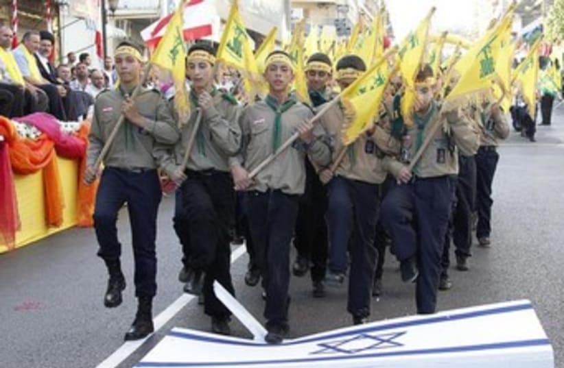 Hezbollah youth stomp on Israeli flag (photo credit: Reuters)