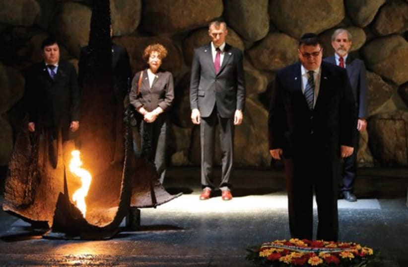 Lithuanian Foreign Minister Linas Linkevicius lays a wreath  (photo credit: AMMAR AWAD / REUTERS)