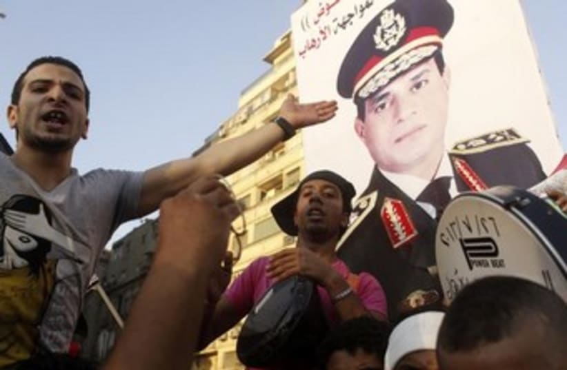 Anti-Morsi protesters hold up Sisi poster 370 (photo credit: REUTERS)