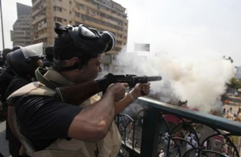 Riot police fire tear gas in Cairo 370 (photo credit: REUTERS)