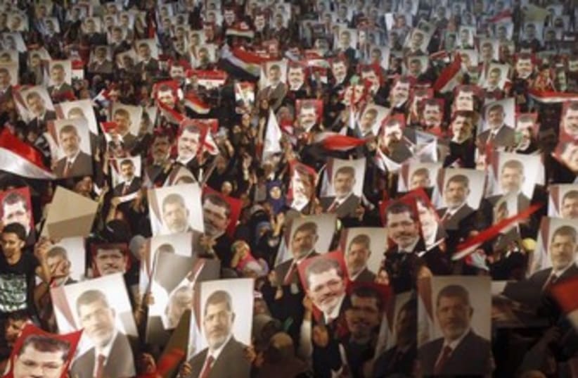Morsi supports hold posters in Cairo 370 (photo credit: REUTERS)