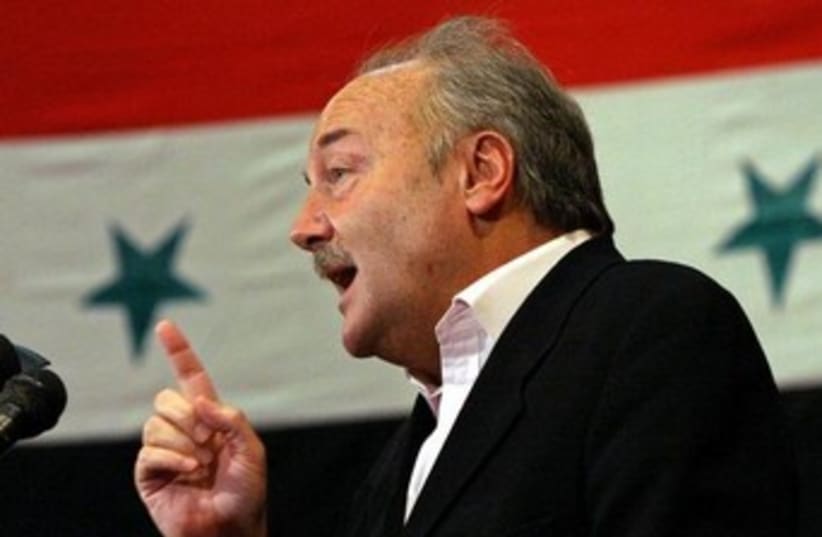 George Galloway with Syria flag (photo credit: REUTERS/Bassam Khabieh)