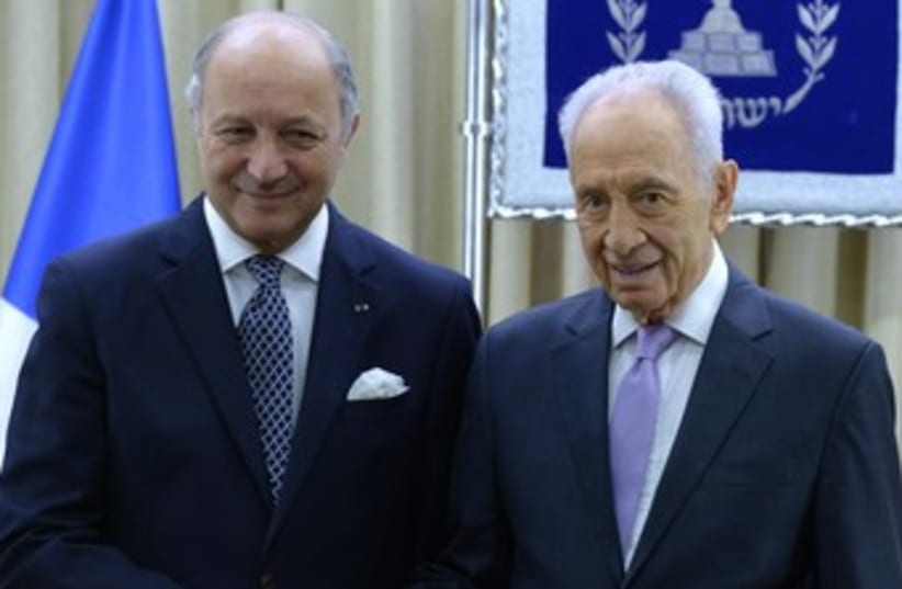 Peres with French FM Laurent Fabius (photo credit: Mark Neiman/GPO)