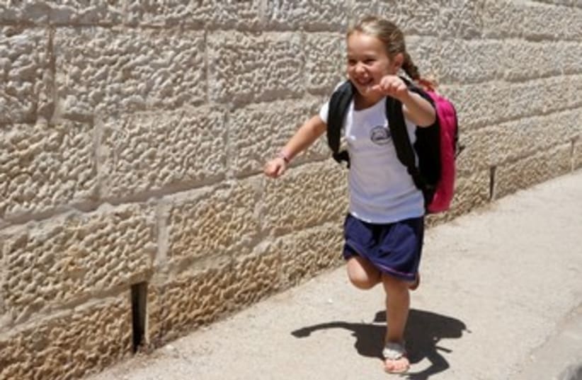 Back to school girl running 370 (photo credit: Marc Israel Sellem/The Jerusalem Post)
