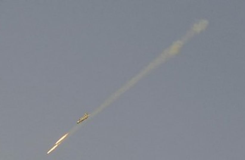A Syrian Air Force fighter plane fires a rocket (photo credit: Reuters)