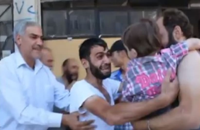 Man reunited with son after chemical weapons  (photo credit: YouTube Screenshot)