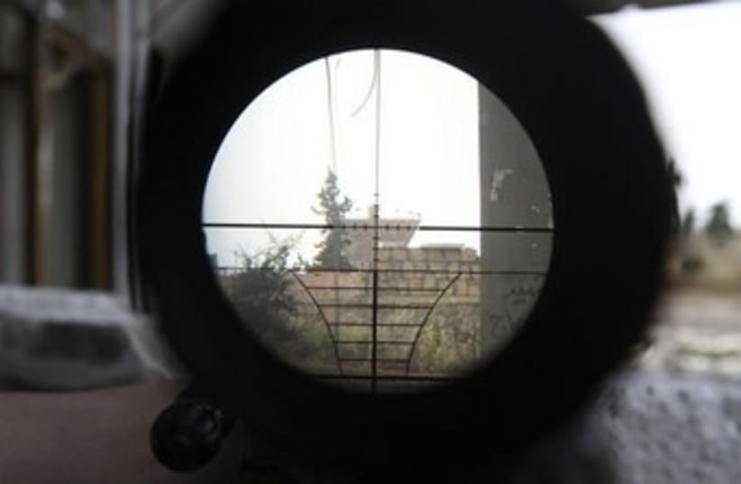 A Syrian regime gathering point is seen through a sniper  (photo credit: Reuters)