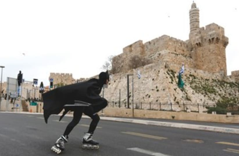 Batman skates in Jerusalem 370 (photo credit: REUTERS)